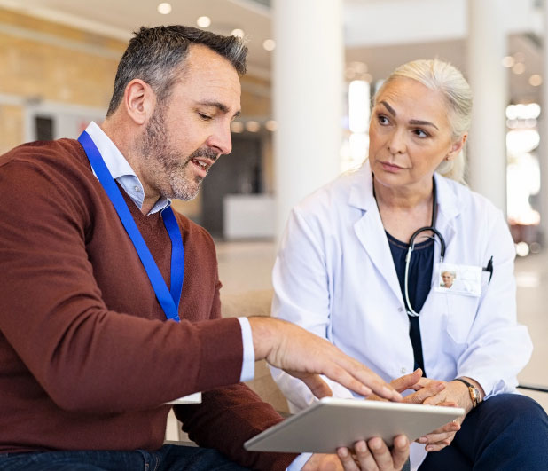 Man and woman discussing careers with tablet