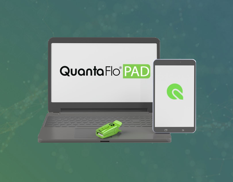 Laptop and tablet showing QuantaFlo logo, sensor on laptop touchpad